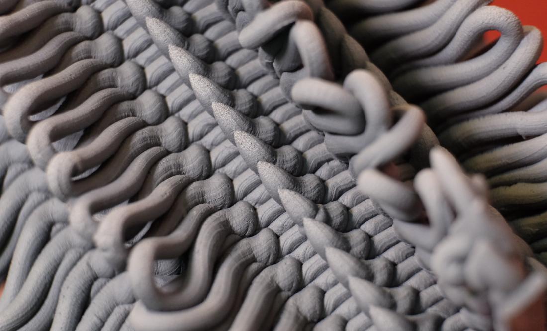 Closeup of a piece's texture. The black clay layers are extruded with a mixture of spikes and looped curves.